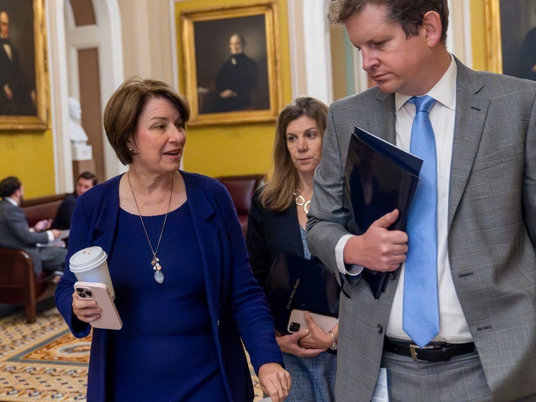 Sen. Amy Klobuchar, D-Minn., left, walks with an aide at the Capitol, Thursday, Sept. 28, 2023, in Washington.