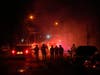 Tear gas surrounds federal law enforcement officers as they leave a scene after a shooting on Wednesday, Jan. 14, 2026, in Minneapolis.