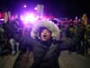 Tear gas surrounds federal law enforcement officers as they leave a scene after a shooting on Wednesday, Jan. 14, 2026, in Minneapolis.