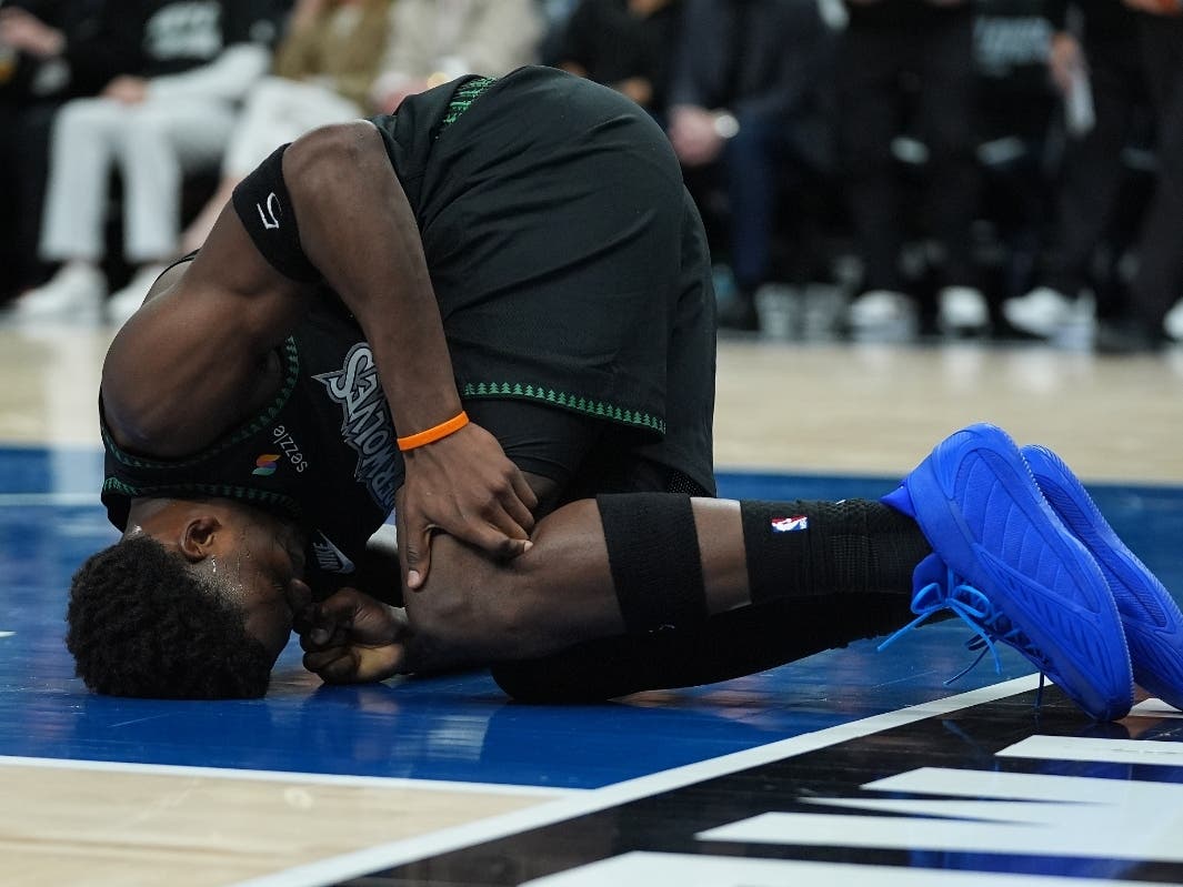 Minnesota Timberwolves guard Anthony Edwards kneels on the court after sustaining an injury during the first half of Game 4 of a first-round NBA basketball playoff series against the Denver Nuggets, Saturday, April 25, 2026, in Minneapolis.