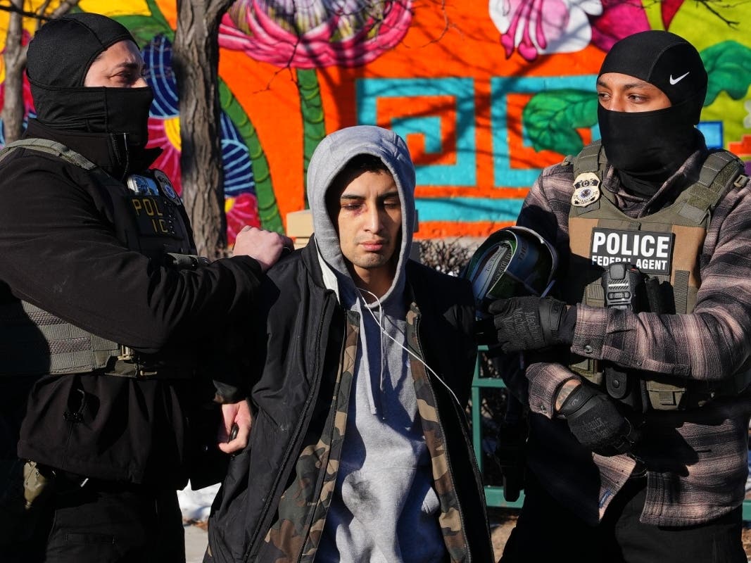 A person is detained by federal immigration officers on Lake Street in Minneapolis, Wednesday, Jan. 14, 2026.