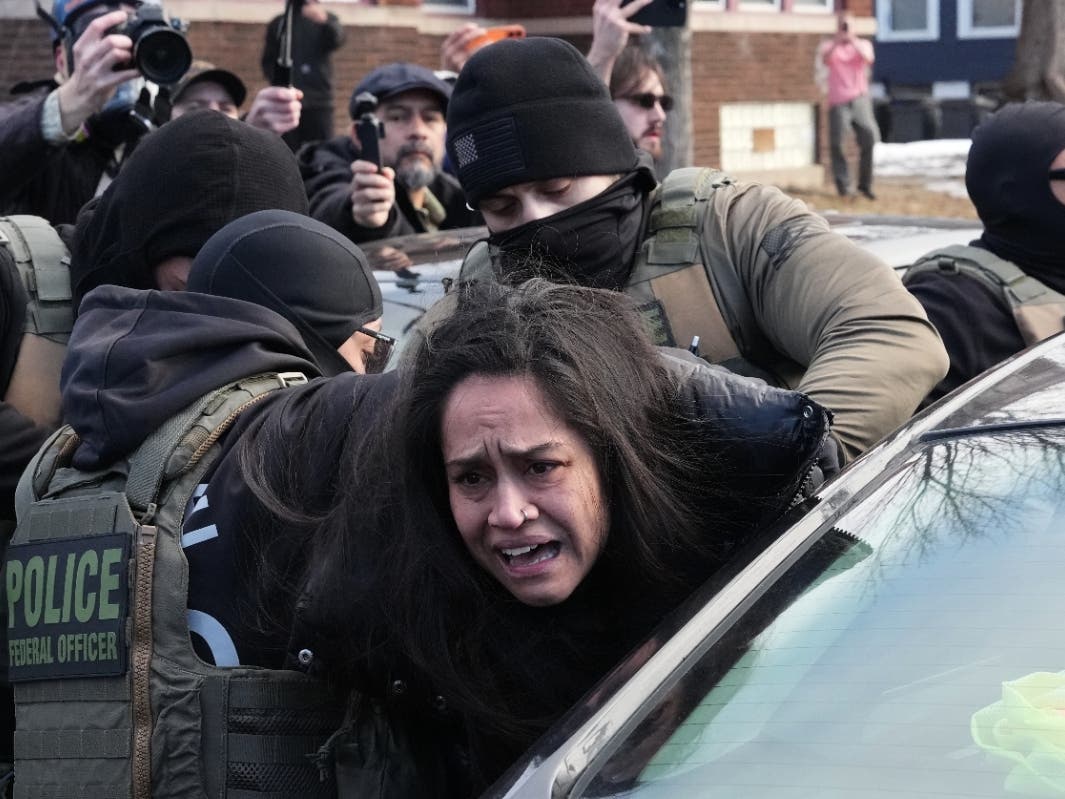 FILE - Aliya Rahman is detained by federal agents near the scene where Renee Good was fatally shot by an ICE officer last week, Jan. 13, 2026, in Minneapolis.