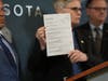 Hennepin County attorney Mary Moriarty holds up a document containing charges against ICE agent Christian Castro during a news conference at the Hennepin County Government Center in Minneapolis, on Monday, May 18, 2026.