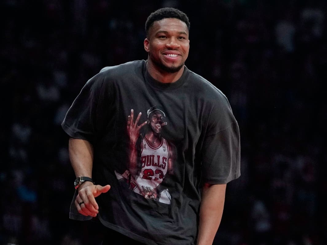 Giannis Antetokounmpo of the Milwaukee Bucks, wearing a shirt featuring Michael Jordan, walks as he attends a EuroLeague playoffs basketball game between Olympiacos and AS Monaco in Piraeus near Athens, Thursday, April 30, 2026.