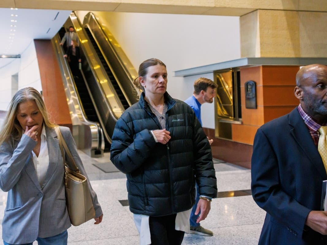FILE - Aimee Bock, founder and executive director of the nonprofit organization Feeding Our Future, arrives at the Minneapolis federal courthouse with her attorney, Ken Udoibok, right, on March 19, 2025, in Minneapolis.