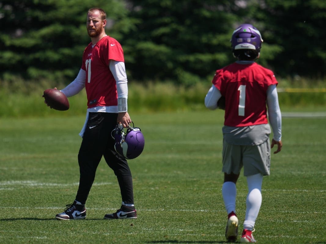 Minnesota Vikings quarterbacks Carson Wentz (11) and Kyler Murray (1) train during an NFL football team practice Wednesday, May 27, 2026, in Eagan, Minn.