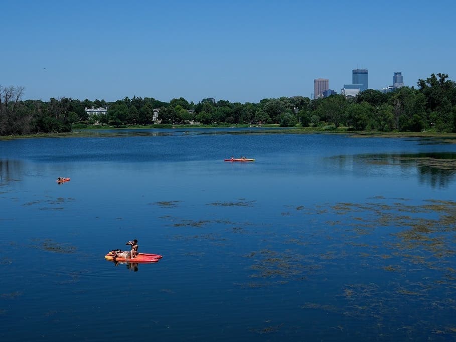 A paddleboarder hydrates on Lake of the Isles during an extreme heat warning Monday, July 13, 2026, in Minneapolis.