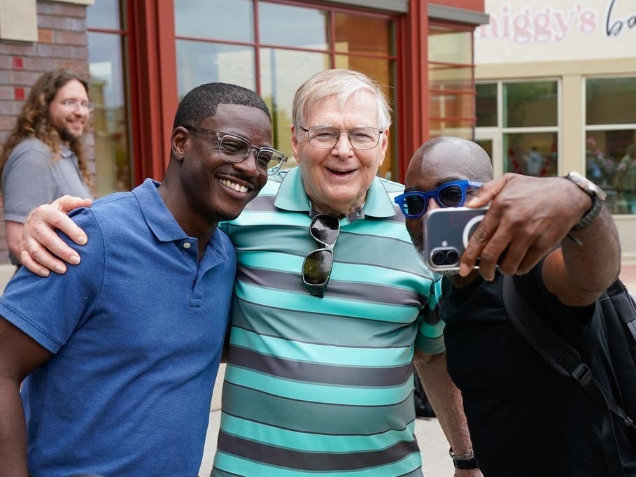 Democratic gubernatorial nominee David Crowley, left, takes a selfie with supporters J. Denny Weaver, center, and Colier McNair after meeting with Democratic leaders at Prairie Cafe and Bakery to kick off his unity tour Wednesday, Aug. 12, 2026.