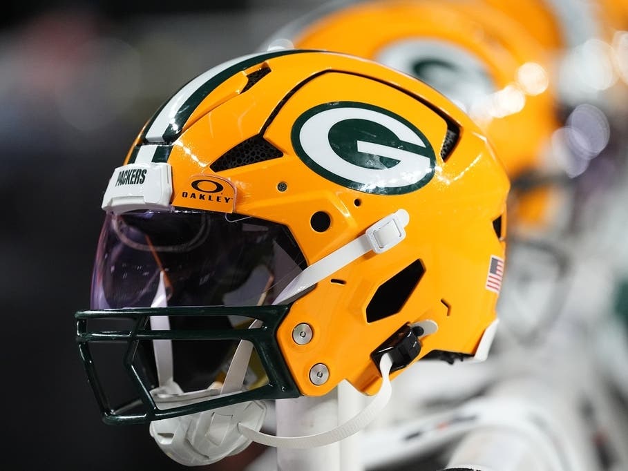Green Bay Packers helmet are lined up on the back of bench in the second half of an NFL preseason football game Friday, Aug. 21, 2026, in Denver.