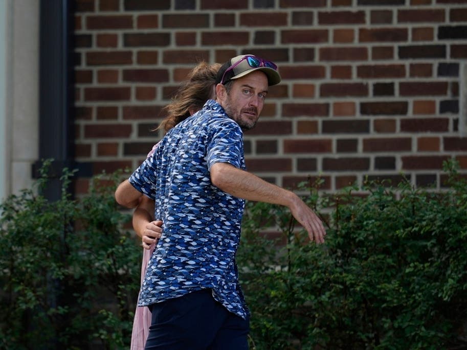 Jesse Merkel, father of student Fletcher Merkel, arrives at the Annunciation Church's school as police respond to a reported mass shooting, Wednesday, Aug. 27, 2025, in Minneapolis. 