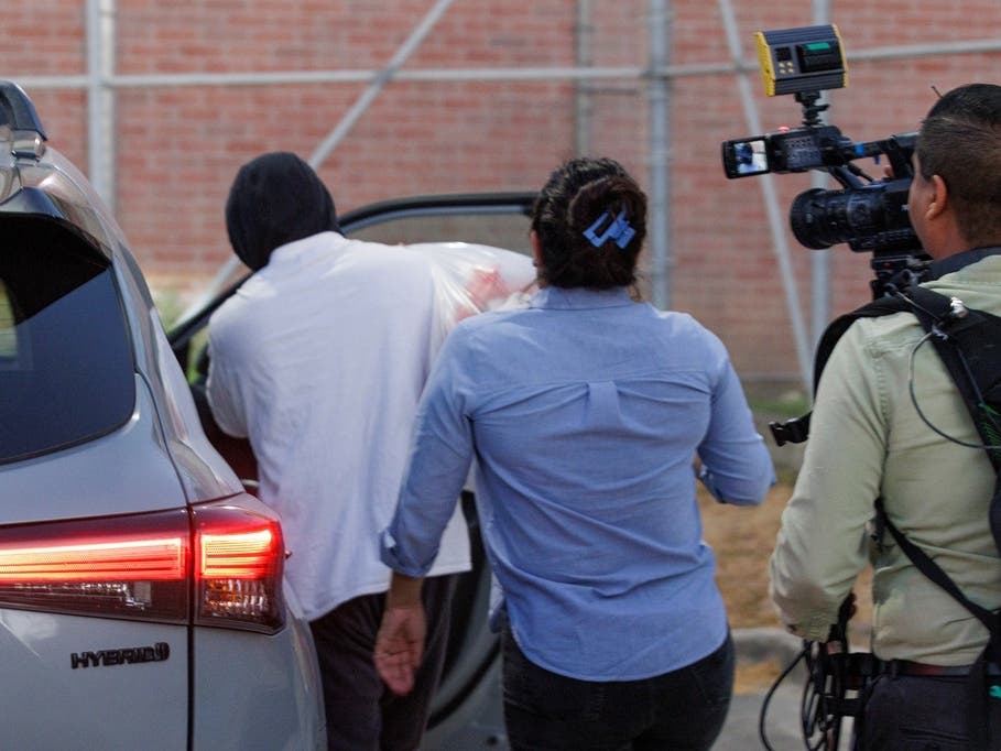 Immigration and Customs Enforcement officer Christian Castro gets into a car surrounded by news reporters moments after being released from the Carrizalez-Rucker Cameron County Detention Center in Brownsville, Texas on Thursday, Aug. 27, 2026. 