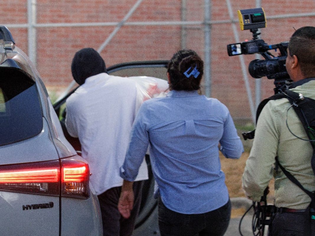 Immigration and Customs Enforcement officer Christian Castro gets into a car surrounded by news reporters moments after being released from the Carrizalez-Rucker Cameron County Detention Center in Brownsville, Texas on Thursday, Aug. 27, 2026.