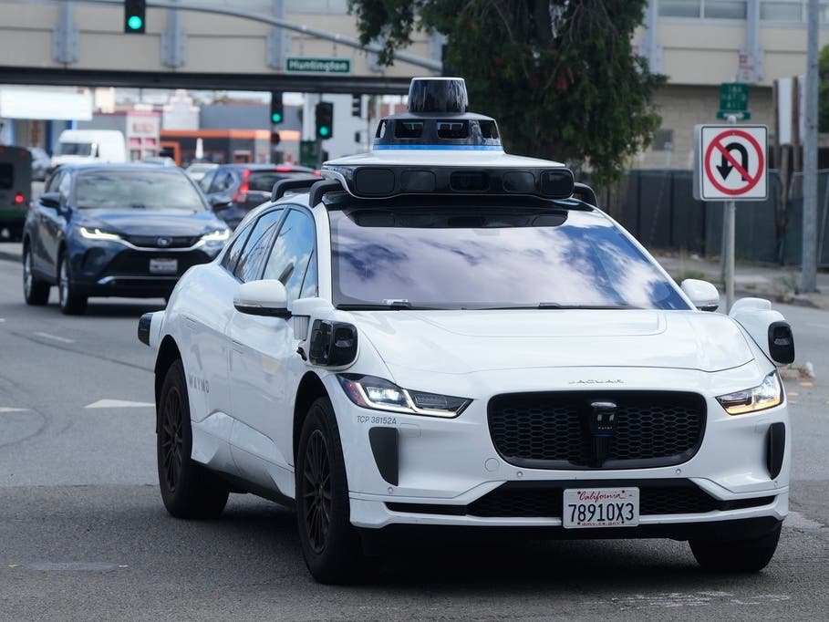 FILE - A Waymo vehicle drives past a No U-Turn sign in San Bruno, Calif., Tuesday, Sept. 30, 2025. 