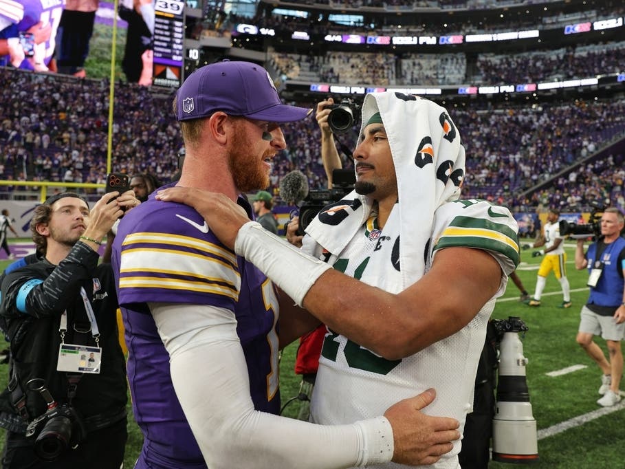Minnesota Vikings quarterback Carson Wentz, left, and Green Bay Packers quarterback Jordan Love, right, greet each other after an NFL football game, Sunday, Sept. 13, 2026, in Minneapolis, Minn.