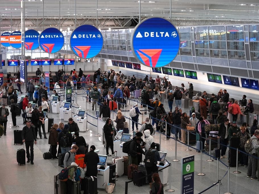 Travelers check in for flights and wait in line to check luggage in Terminal 1 at Minneapolis-St. Paul Airport after a snowstorm Monday, March 16, 2026, in Minneapolis.