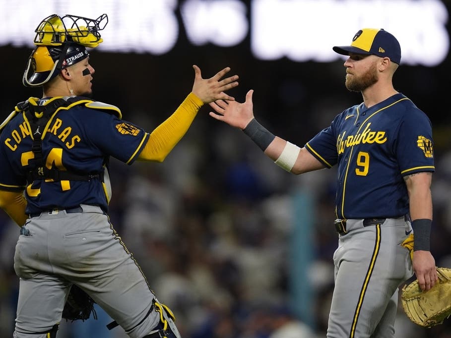 Milwaukee Brewers catcher William Contreras (24) and first baseman Jake Bauers (9) celebrate after Game 3 of baseball's National League Championship Series between the Milwaukee Brewers and the Los Angeles Dodgers, Wednesday, Oct. 14, 2026, in Los Angeles