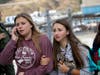 Students are escorted out of Saugus High School as some parents join them after reports of a shooting on Thursday, Nov. 14, 2019, in Santa Clarita, Calif. 