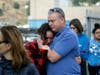 Students are escorted out of Saugus High School as some parents join them after reports of a shooting on Thursday, Nov. 14, 2019, in Santa Clarita, Calif. 