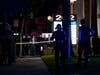 Investigators gather outside an office building where a shooting occurred in Orange,Wednesday, March 31, 2021. The shooting killed several people, including a child, and injured another person before police shot and wounded the suspect, police say