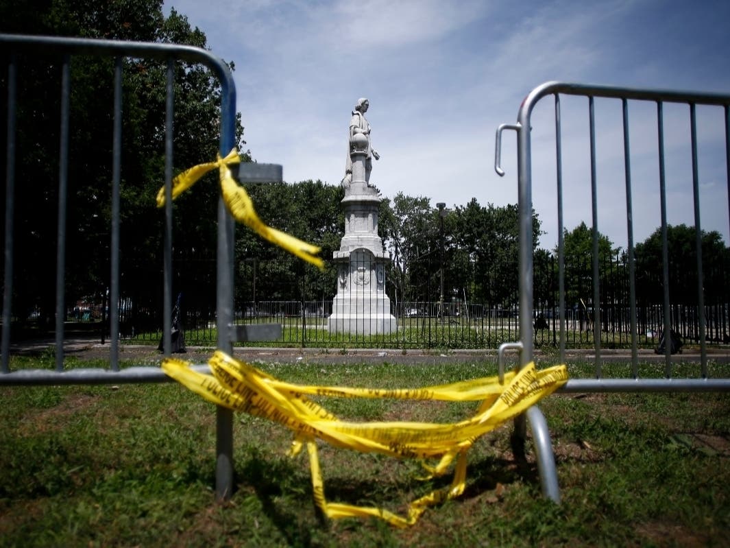 A statue of Christopher Columbus is seen behind barricades at Marconi Plaza, Monday, June 15, 2020, in the South Philadelphia neighborhood of Philadelphia.