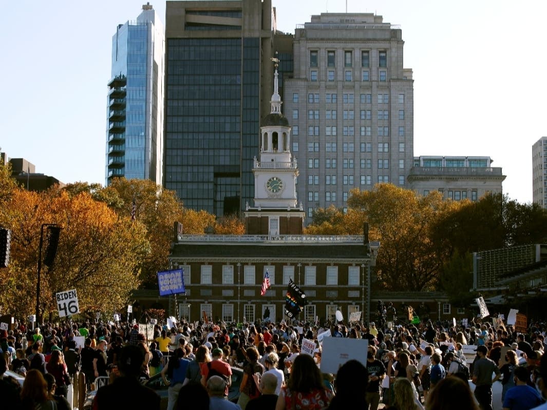 People celebrate outside Independence Hall, Saturday, Nov. 7, 2020, in Philadelphia, after Democrat Joe Biden defeated President Donald Trump to become 46th president of the United States.