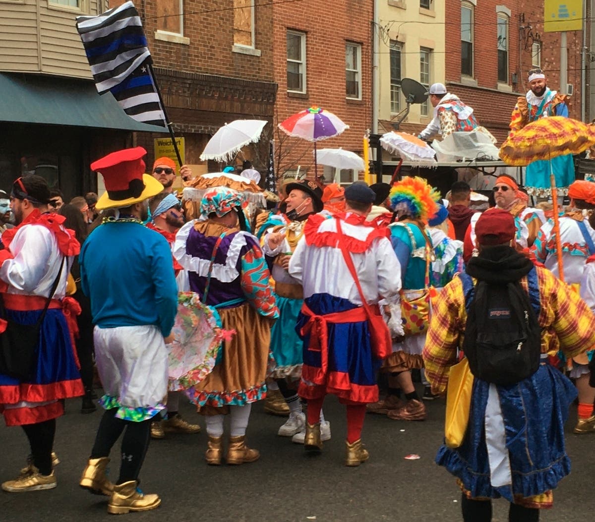 Costumed participants take to the streets of their south Philadelphia stomping grounds for a New Year’s celebration of Mummers tradition despite official cancellation of the annual event and a ban on large gatherings due to the coronavirus pandemic.