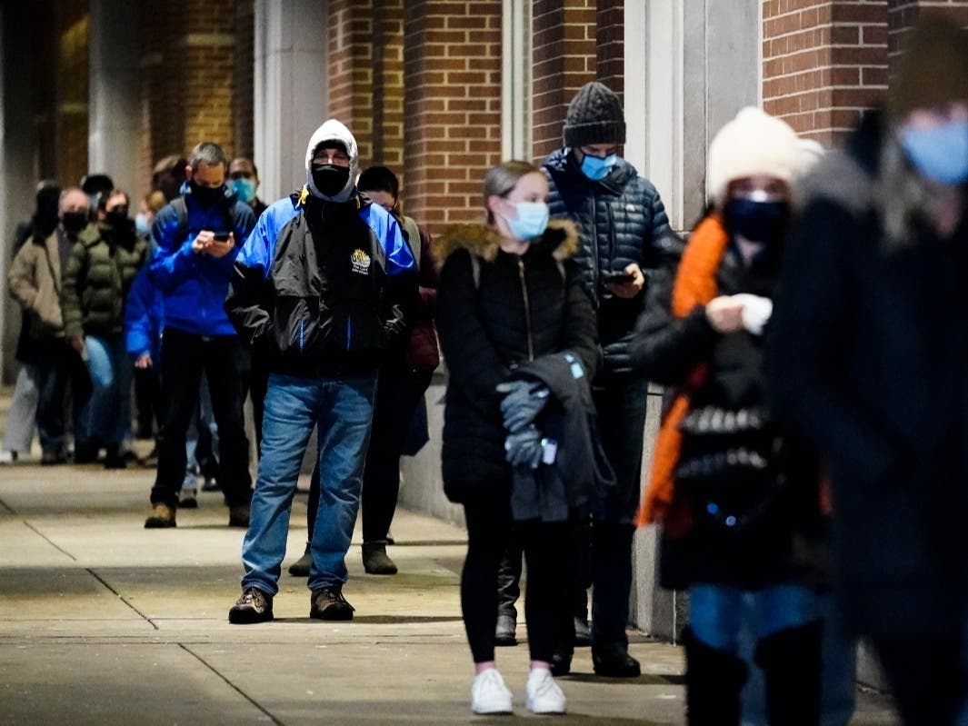 People wait in line at a COVID-19 vaccination site at the Pennsylvania Convention Center in Philadelphia. The clinic opened to help provide second doses of COVID-19 vaccinations.