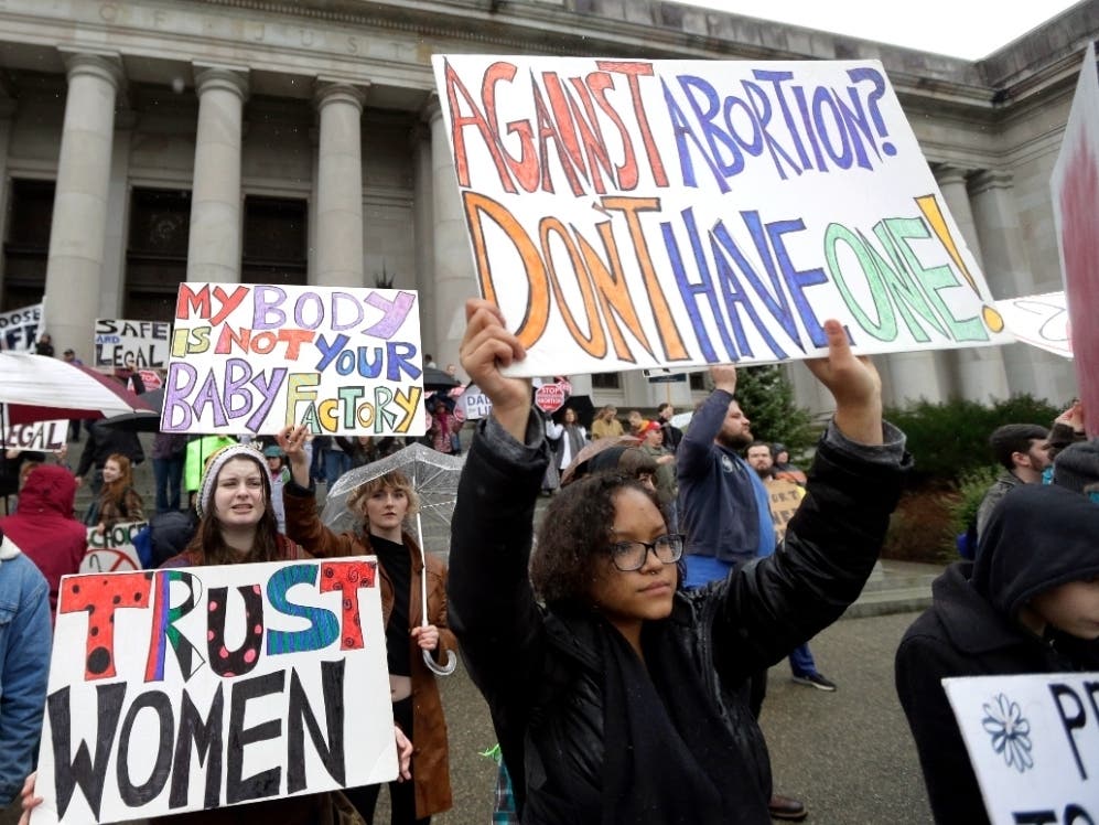 Protestors supporting abortion rights demonstrate Tuesday, Jan. 19, 2016, during an anti-abortion protest at the Capitol in Olympia, Wash.