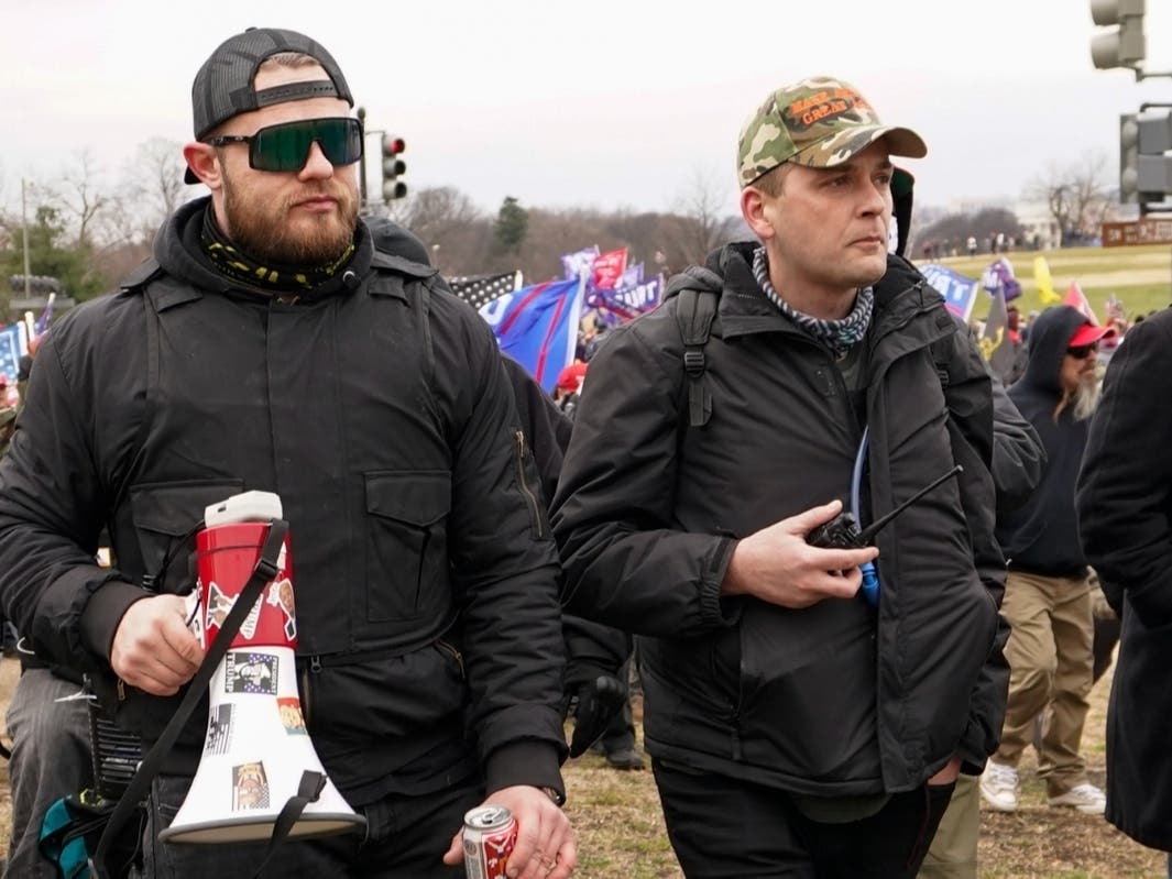 In this Jan. 6, 2021, photo, Proud Boys members Ethan Nordean, left, and Zachary Rehl walk toward the U.S. Capitol in Washington, in support of President Donald Trump.