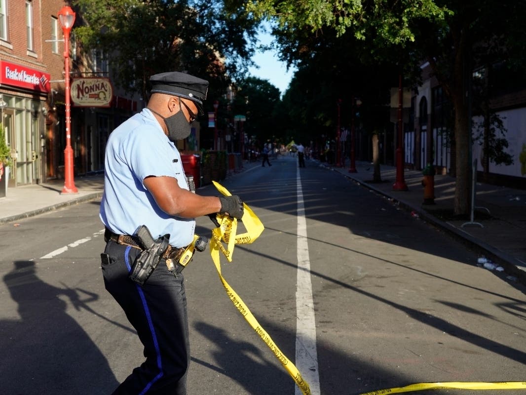 Philadelphia Police investigators work the scene of a fatal overnight shooting on South Street in Philadelphia, Sunday, June 5, 2022.