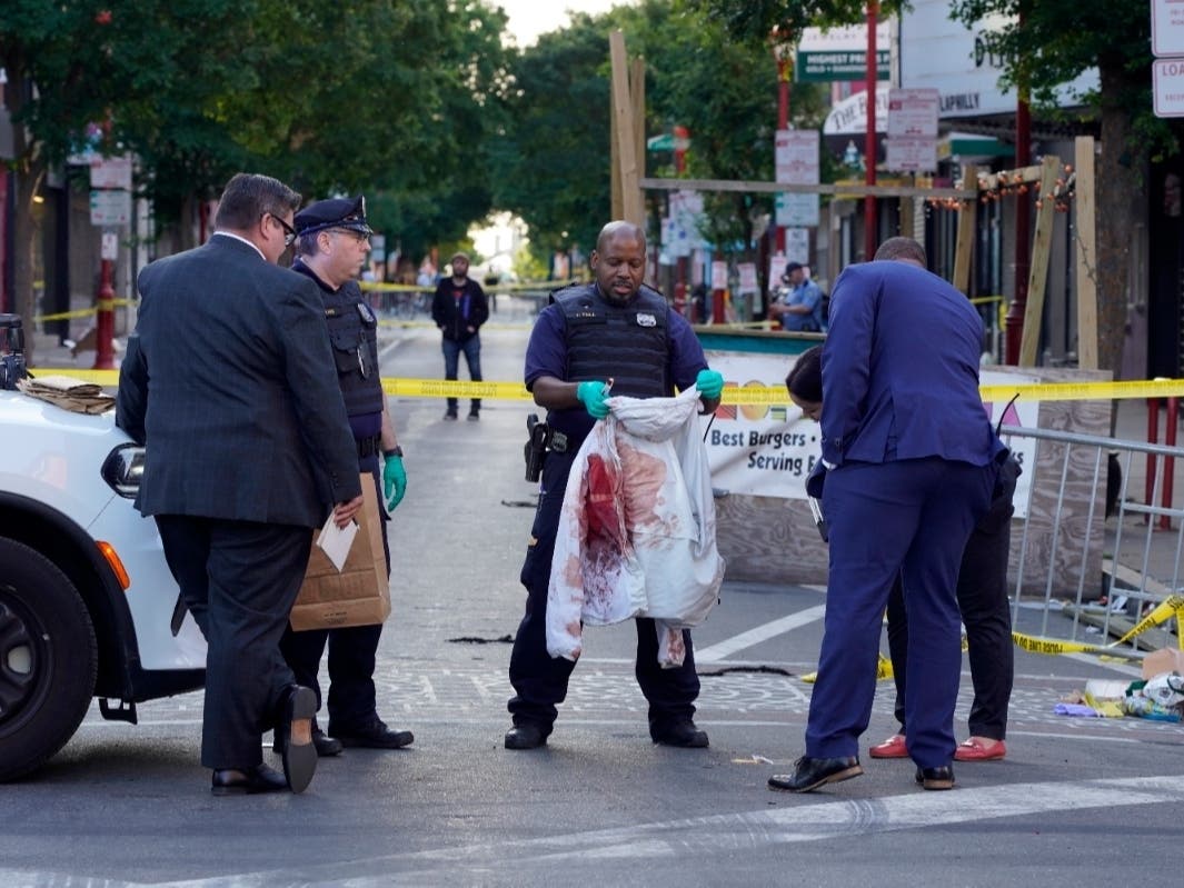 Philadelphia Police investigators work the scene of a fatal overnight shooting on South Street in Philadelphia, Sunday, June 5, 2022.