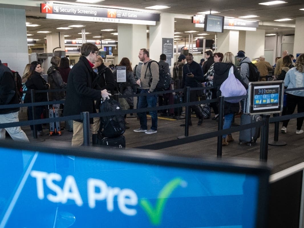 Passengers wait in line at a Transportation Security Administration checkpoint at the Philadelphia International Airport in Philadelphia, Friday, Jan. 11, 2019.