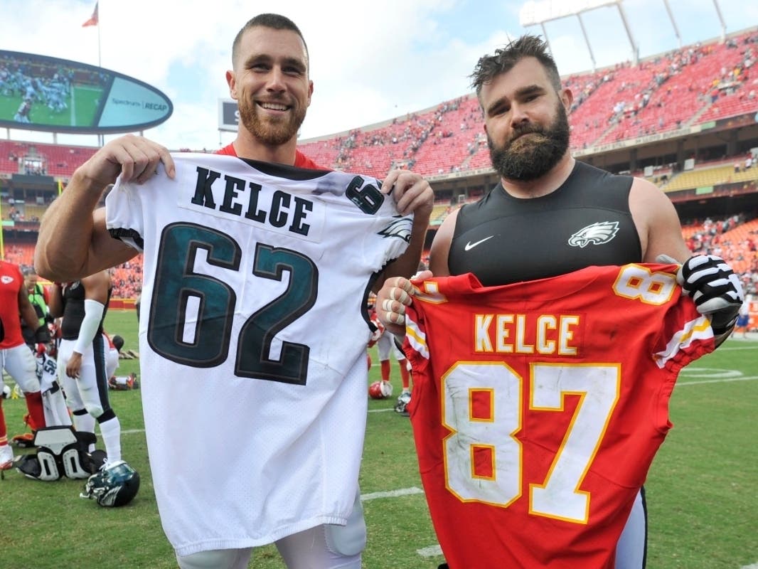 Kansas City Chiefs tight end Travis Kelce, left, and his brother, Philadelphia Eagles center Jason Kelce (62) exchange jerseys following an NFL football game in Kansas City, Mo., on Sept. 17, 2017.