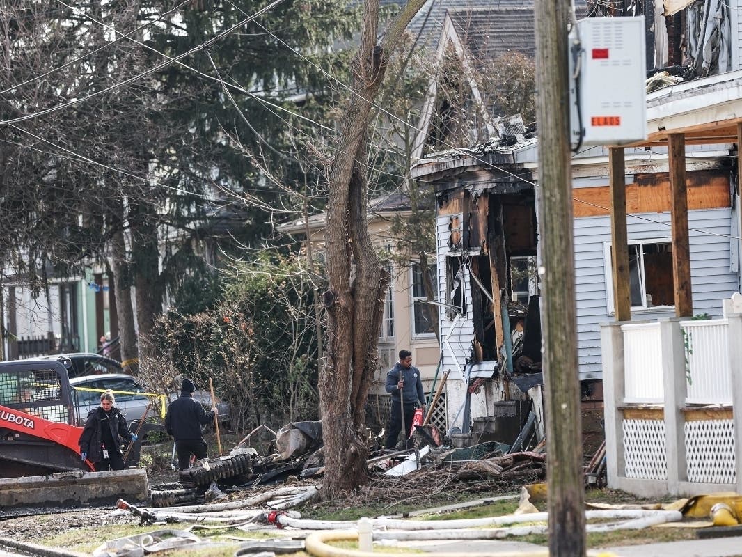 Investigators work at the scene where two police officers were injured while responding to reported standoff in East Lansdowne, Pa., Thursday, Feb. 8, 2024.
