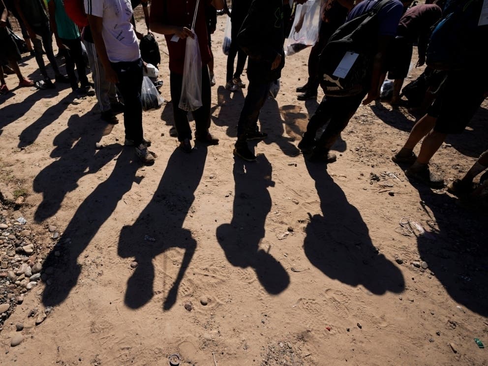 Migrants wait to be processed by the U.S. Customs and Border Patrol after they crossed the Rio Grande and entered the U.S. from Mexico, Oct. 19, 2023, in Eagle Pass, Texas.