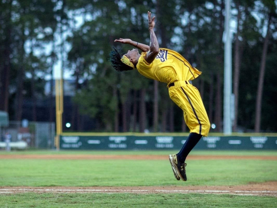 Savannah Bananas' dancing first base coach Maceo Harrisoin performs a back-flip in the coach's box during the team's baseball game against the Wilmington Sharks, Saturday, June 11, 2022, in Savannah, Ga.