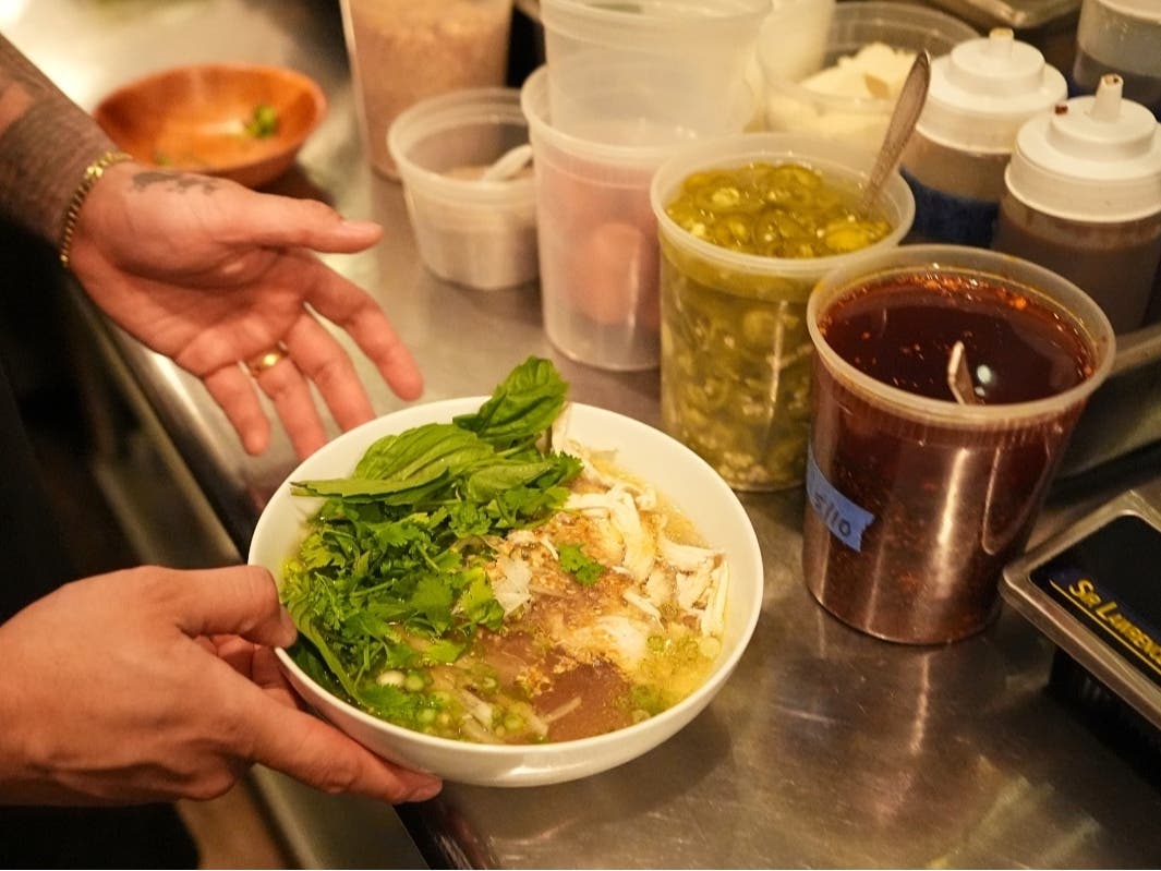 Chef Phila Lorn holds a bowl of the The Mawn Noodle soup at his restaurant, Mawn, in Philadelphia, Thursday, May 22, 2025.
