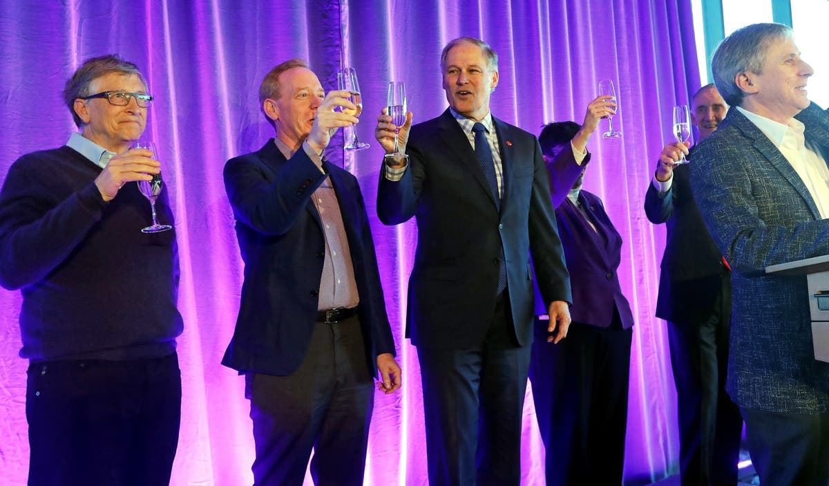 Bill Gates, Microsoft President Brad Smith, and Gov. Jay Inslee toast at the opening of a UW computer school Feb. 28. 