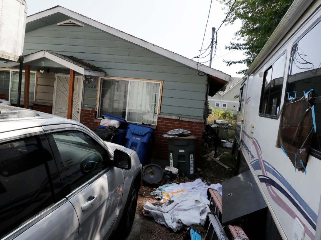 Vehicles are parked outside the home of Paige A. Thompson, who uses the online handle "erratic," Wednesday, July 31, 2019, in Seattle.