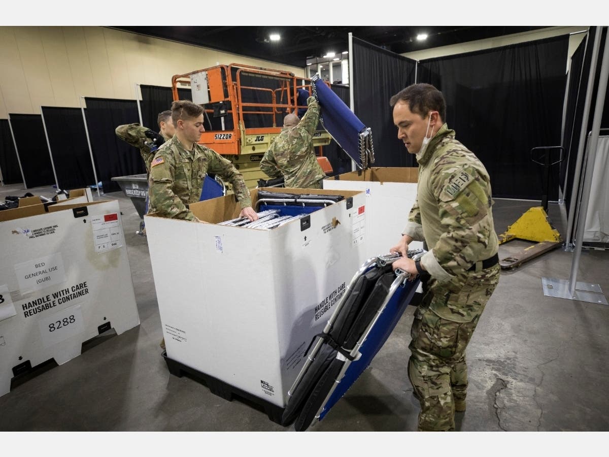 Members of the Massachusetts National Guard erect a medical field hospital at the DCU Center in Worcester on April 1 for the expected influx of patients due to the COVID-19 pandemic.