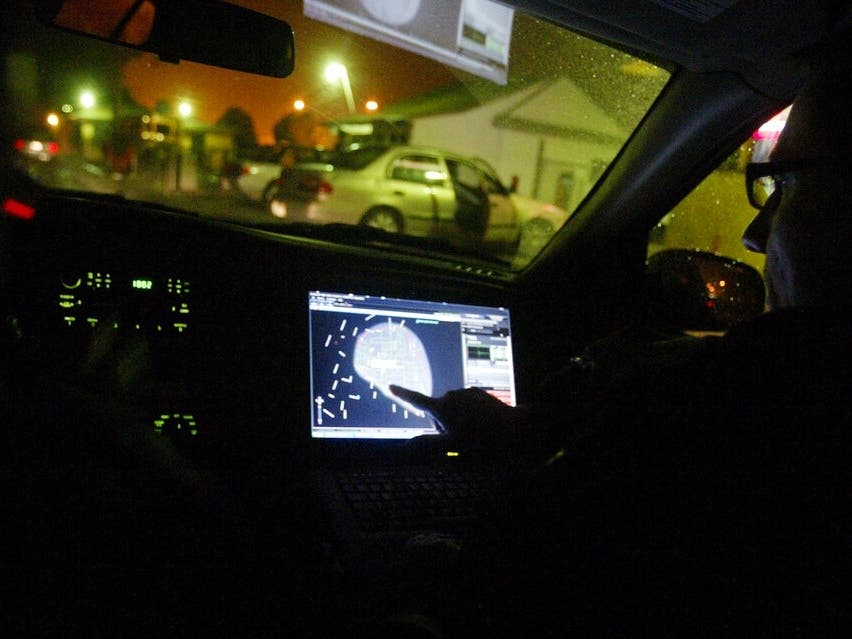 In this Dec. 31, 2008, file photo, engineer Stephan Noetzel alerts an officer to gunshots using ShotSpotter in East Palo Alto, Calif. Worcester uses the company's gunshot detection devices and the new AI policing tool called ShotSpotter Connect.