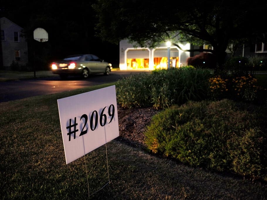 A sign displays "#2069," the number of deaths that the Massachusetts Department of Public Health estimates were caused by opioid-related overdoses in a single year, on the lawn of Lynn Wencus, in Wrentham June 20, 2018. Her son, Jeff, overdosed in 2017.