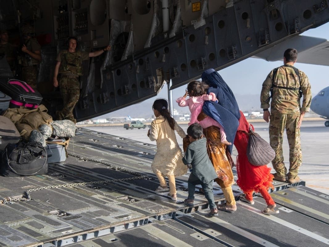 People being evacuated from Taliban-controlled Afghanistan Tuesday embark on a U.S. Air Force C-17 at Hamid Karzai International Airport in Kabul.