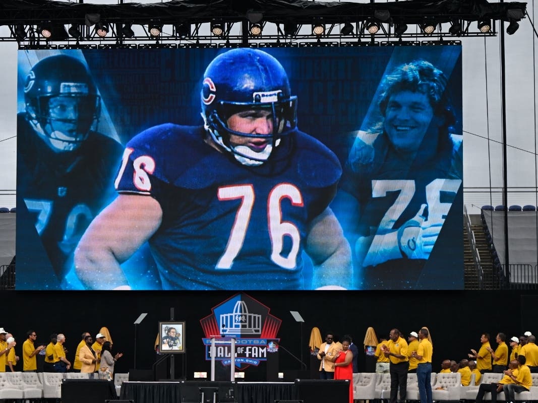 A video board displays an image of former NFL player Steve McMichael during his induction into the Pro Football Hall of Fame, in Canton, Ohio, Saturday, Aug. 3, 2024. 