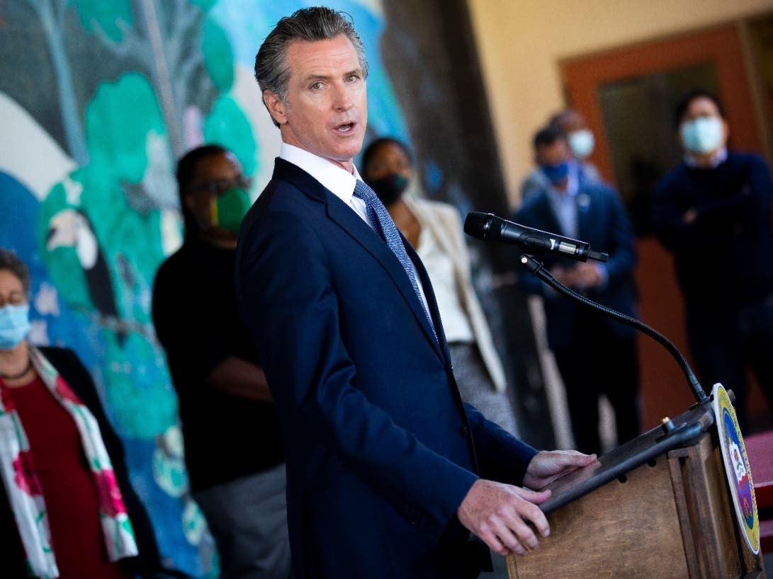 In this Aug. 11, 2021, file photo, California Gov. Gavin Newsom speaks with reporters at Carl B. Munck Elementary School in Oakland, Calif. 
