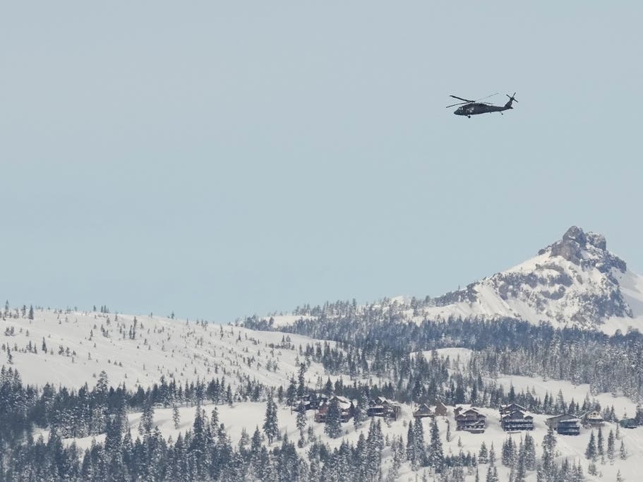 A U.S. Army Blackhawk helicopter flies toward the Castle Peak area as recovery efforts for a group of missing skiers continue in Truckee, Calif., Saturday, Feb. 21, 2026. 