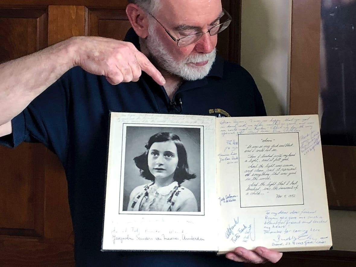In this June 7, 2019 photo, Ryan Cooper holds a 1972 portion of a diary that he wrote when he visited Otto Frank.