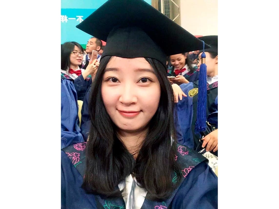 This 2016 selfie provided by her family shows Yingying Zhang in a cap and gown for her graduate degree.