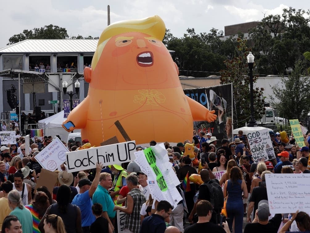 An inflatable Baby Trump balloon towers over protestors during a rally Tuesday, June 18, 2019, in Orlando, Florida.