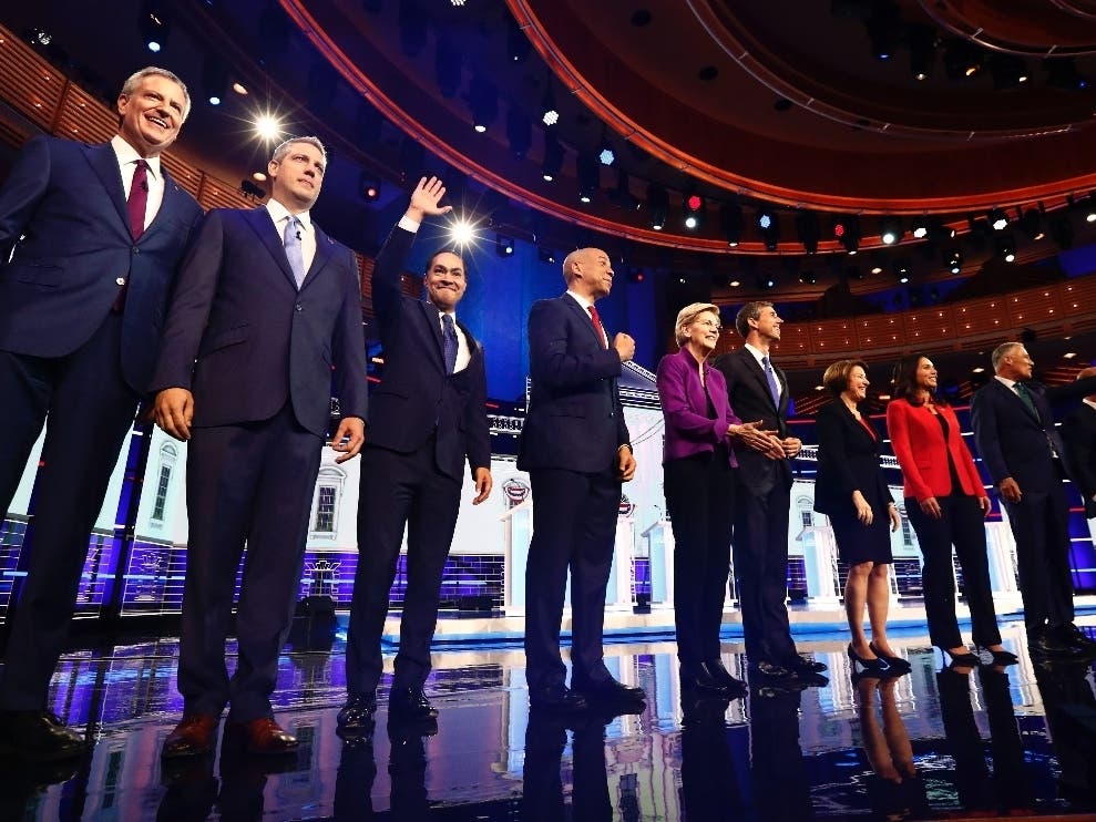 The Democratic candidates pose for a photo on stage before the start of a Democratic primary debate Wednesday, June 26,.
